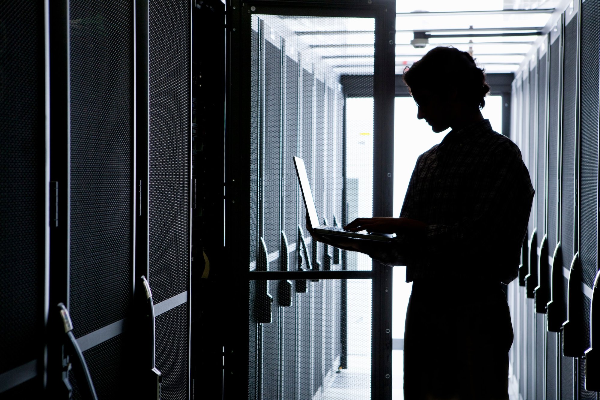 medium-silhouette-shot-of-a-technician-using-a-lap-2026-01-11-09-39-42-utc