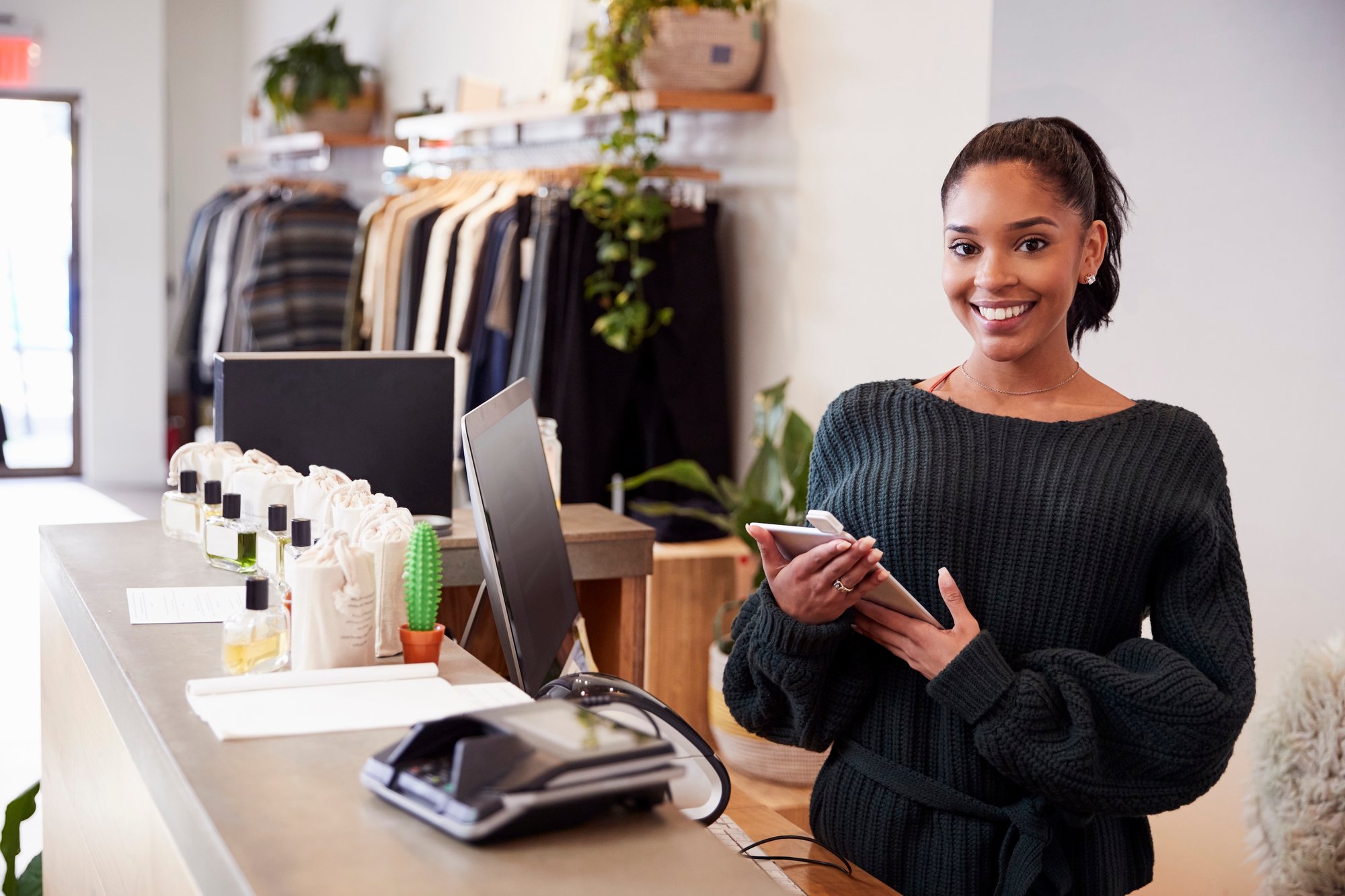 female-assistant-smiling-from-the-counter-in-cloth-2026-01-05-06-33-52-utc