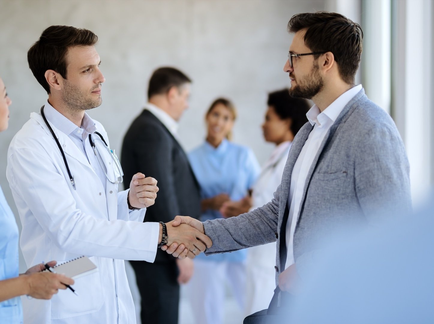 professional-handshake-between-doctor-and-business-2026-01-06-10-08-42-utc 2-1